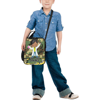 a little boy holding a bag with a picture of a boy on it