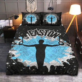 a bed with a black and blue comforter with a picture of a man holding