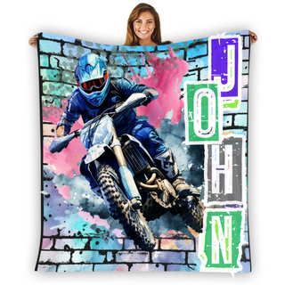 a woman holding a blanket with a picture of a dirt bike rider