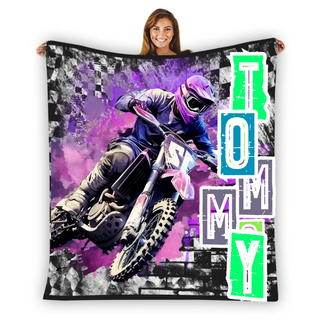 a woman is holding a blanket with a picture of a motorcyclist