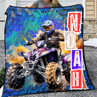 a woman holding a blanket with a picture of a person on a atv