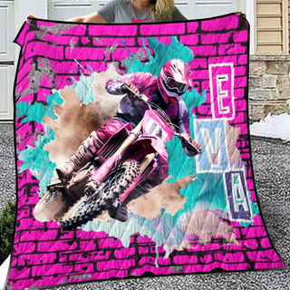 a woman holding a pink dirt bike blanket