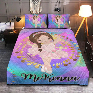 a bed with a colorful comforter with a picture of a girl on it