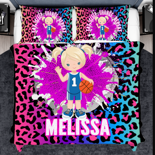 a girl with a basketball on a pink and blue leopard print bed set