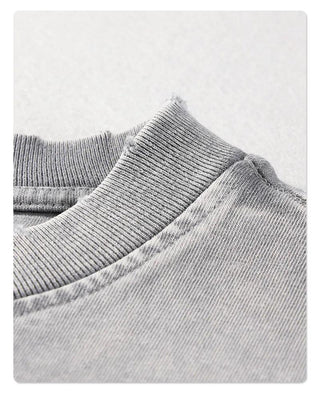 a close up of a gray sweater on a white background