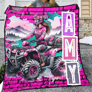 a woman holding up a pink and purple blanket