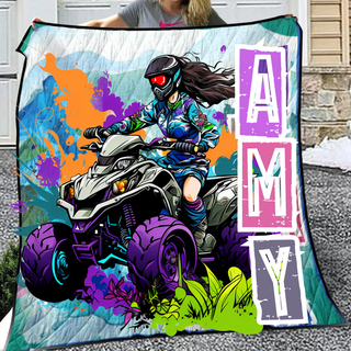 a woman holding a blanket with a picture of a girl on a atv