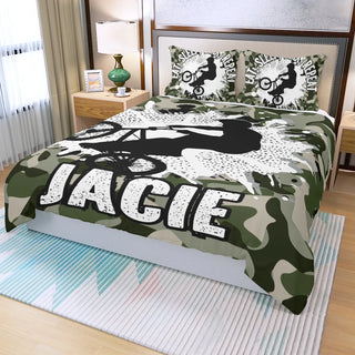 a bed with a camouflage comforter and pillows