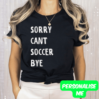 a woman wearing a black shirt that says sorry can't soccer bye