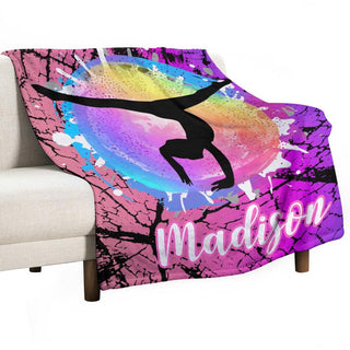 a pink and purple throw blanket with a girl doing a handstand on a