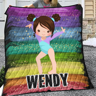 a woman holding a quilt with a picture of a girl on it