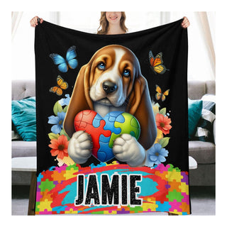 a woman holding a blanket with a dog on it