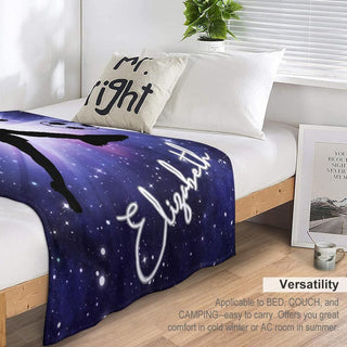 a bed with a blanket that has a picture on it