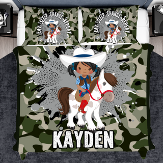 a bed with a camo print and a cowboy on a horse