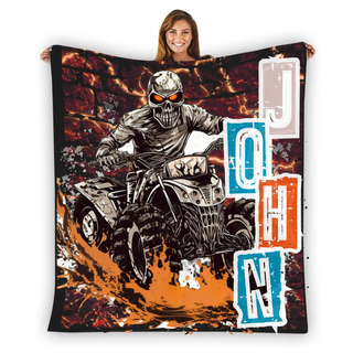 a woman holding a blanket with a picture of a skeleton riding a motorcycle