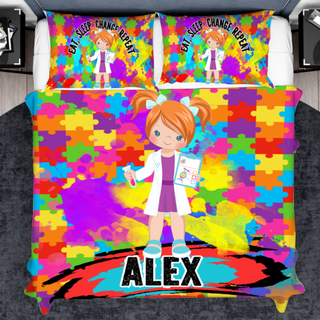 a bed with a colorful bed cover with a girl on it