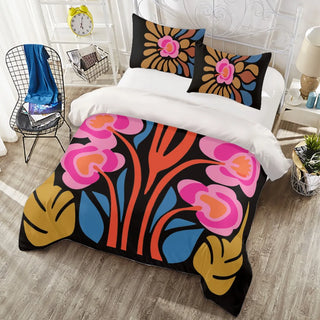 a bed covered in a colorful comforter and pillows