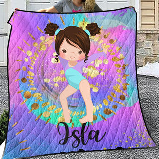 a girl holding up a purple and blue quilt