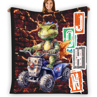 a woman holding up a blanket with a picture of a dinosaur riding a four wheeler