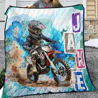 a woman holding a blanket with a picture of a dirt bike rider