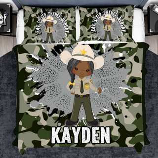 a bed with a camo print and a black girl in a sheriff's