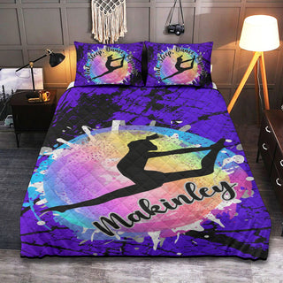 a bed with a purple comforter with a picture of a person on it