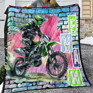 a woman holding up a blanket with a picture of a motorcyclist on