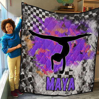 a woman standing next to a purple and black blanket