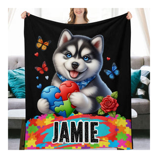 a woman holding a blanket with a husky dog on it