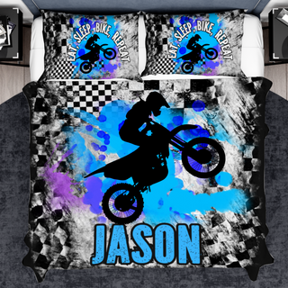 a bed with a black and white picture of a person on a dirt bike