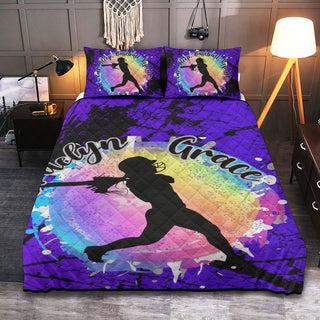 a bed with a purple comforter with a picture of a girl on it