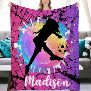 a woman holding a personalized soccer blanket