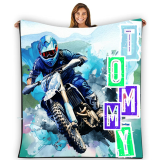 a woman holding a blanket with a picture of a motorcyclist