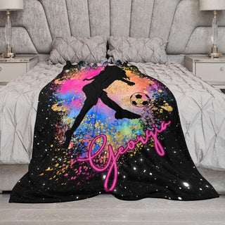 a bed covered in a blanket with a girl on it