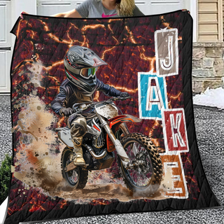 a woman holding a blanket with a picture of a dirt bike rider