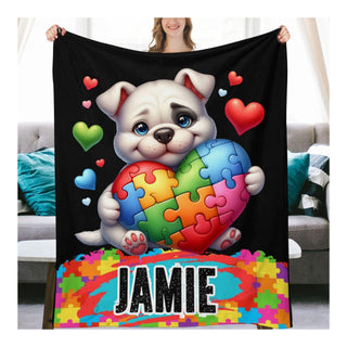 a woman holding a blanket with a picture of a dog holding a puzzle heart