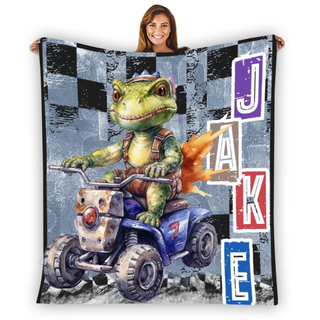 a woman holding up a blanket with a picture of a turtle riding a four wheeler