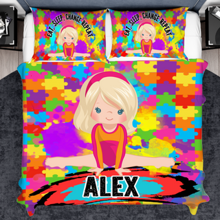 a bed with a colorful bed cover with a picture of a girl on it