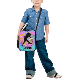 a young boy is holding a bag with a girl on it