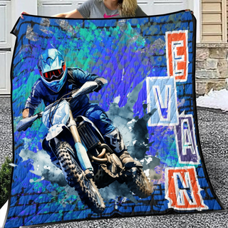 a woman holding a blanket with a picture of a motorcyclist on it