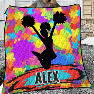 a woman holding a colorful blanket with a cheerleader on it