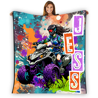 a woman holding up a colorful blanket with a picture of a girl on a quad