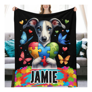 a woman holding a blanket with a dog holding a puzzle heart