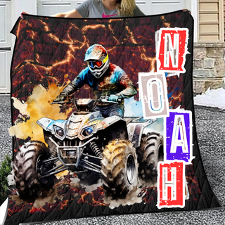 a woman holding a blanket with a picture of a person on a atv