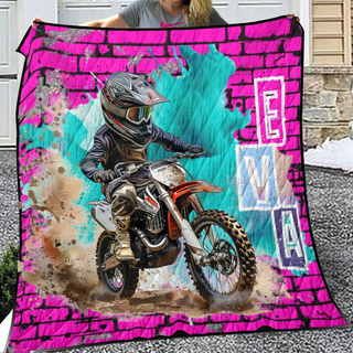 a woman holding a blanket with a dirt bike on it