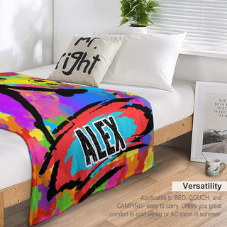 a bed with a colorful comforter on top of it