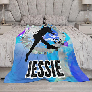 a bed with a soccer themed comforter on it