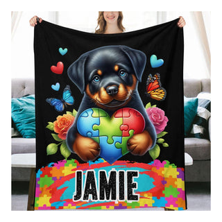 a woman holding a blanket with a dog holding a puzzle