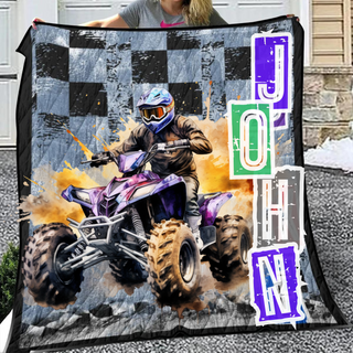 a woman holding a blanket with a picture of a person on a atv