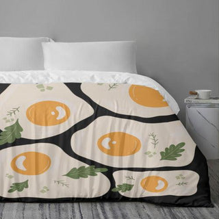 a bed with an orange and black pattern on it